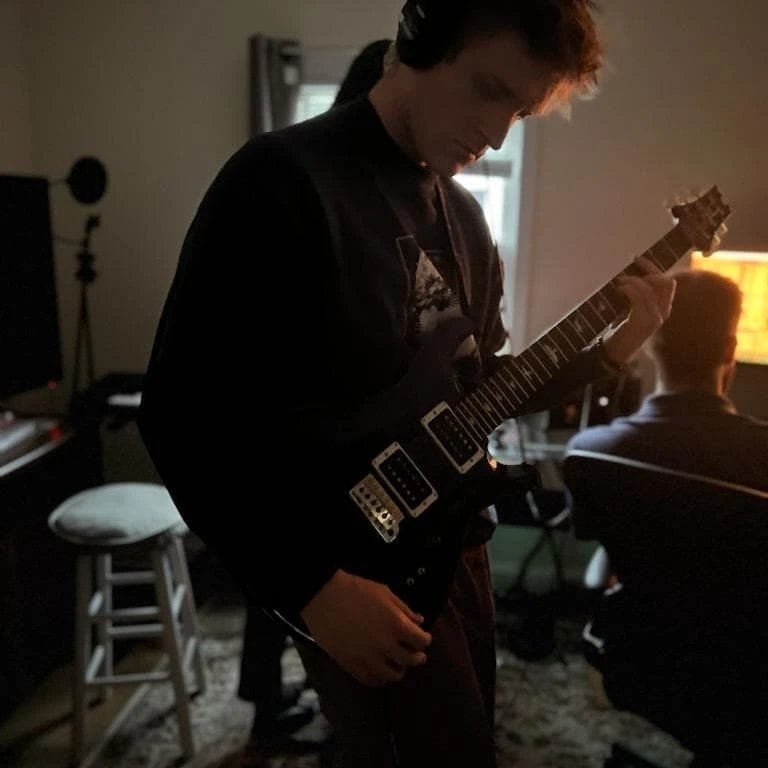 Grayson playing guitar